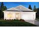 Charming single-story home with white brick, attached two-car garage, manicured lawn, and welcoming front entrance at 7759 Halifax Way, Fairburn, GA 30213