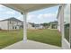 View of a spacious backyard with a covered patio, ideal for outdoor living and entertaining at 7760 Sheffield Ter, Fairburn, GA 30213