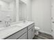 Bathroom featuring dual sinks, gray cabinets, modern fixtures, and a shower at 7760 Sheffield Ter, Fairburn, GA 30213