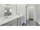 Bathroom featuring double sinks, quartz countertops and gray cabinets at 7760 Sheffield Ter, Fairburn, GA 30213
