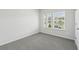 Bright bedroom with gray carpet, large windows, and natural light at 7760 Sheffield Ter, Fairburn, GA 30213