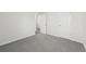 A large bedroom showcasing neutral walls and gray carpeting at 7760 Sheffield Ter, Fairburn, GA 30213
