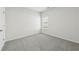 Light filled bedroom featuring neutral gray carpet and bright white walls at 7760 Sheffield Ter, Fairburn, GA 30213