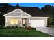 Charming single-story home featuring stone accents, a two-car garage, and a welcoming front porch at 7760 Sheffield Ter, Fairburn, GA 30213