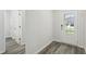 Bright foyer with wood-look flooring, leading to other rooms in the home at 7760 Sheffield Ter, Fairburn, GA 30213