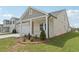 Inviting single-story home with a covered porch and manicured landscaping at 7760 Sheffield Ter, Fairburn, GA 30213