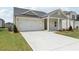 Attractive single-story home with a spacious driveway and a well-maintained lawn at 7760 Sheffield Ter, Fairburn, GA 30213