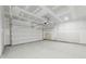 Spacious two car garage with white door and concrete floor at 7760 Sheffield Ter, Fairburn, GA 30213