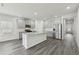 Modern kitchen with stainless appliances, center island, and stylish gray cabinets at 7760 Sheffield Ter, Fairburn, GA 30213