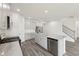 Open kitchen with island, stainless appliances, gray cabinets, and wood-style floors at 7760 Sheffield Ter, Fairburn, GA 30213