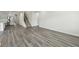 Open-concept area that flows into the kitchen, featuring stylish flooring and ample space at 7760 Sheffield Ter, Fairburn, GA 30213