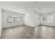 Large living area featuring many windows and stylish flooring for comfortable living at 7760 Sheffield Ter, Fairburn, GA 30213