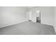 Spacious main bedroom with gray carpet and ensuite bathroom at 7760 Sheffield Ter, Fairburn, GA 30213