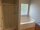 Bathroom featuring shower, tub, and window at 1247 To Lani Farm Rd, Stone Mountain, GA 30083