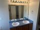 Bathroom featuring double sinks, vanity, and mirror with lighting at 1247 To Lani Farm Rd, Stone Mountain, GA 30083