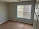 Bedroom with neutral walls, carpet, and natural light from the window at 1247 To Lani Farm Rd, Stone Mountain, GA 30083