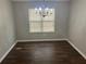 Dining room with hardwood floors, a classic chandelier, and a large window at 1247 To Lani Farm Rd, Stone Mountain, GA 30083