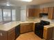 Bright kitchen boasts an island, wood cabinets, modern appliances, and a large bay window at 1247 To Lani Farm Rd, Stone Mountain, GA 30083