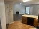 Open kitchen with hardwood floors, wood cabinets, modern appliances, and a view of the living room at 1247 To Lani Farm Rd, Stone Mountain, GA 30083