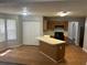 Kitchen features an island, laminate floors, wood cabinets, and modern appliances at 1247 To Lani Farm Rd, Stone Mountain, GA 30083