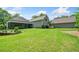 Expansive backyard with manicured lawn, landscaping, and views of the rear exterior of the house at 132 Copper Hills Dr, Canton, GA 30114