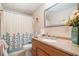 Neutral bathroom featuring shower with decorative curtain, vanity, and ample counter space at 132 Copper Hills Dr, Canton, GA 30114