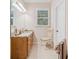 Well-lit bathroom featuring a granite countertop, tiled floors, and ample natural light at 132 Copper Hills Dr, Canton, GA 30114