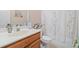 Neat bathroom with a floral shower curtain, sink, and white toilet at 132 Copper Hills Dr, Canton, GA 30114