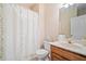 Well-lit bathroom featuring a floral shower curtain and a light wood vanity at 132 Copper Hills Dr, Canton, GA 30114