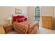 Cozy bedroom featuring a bright window, plush red bedding, and wooden furniture at 132 Copper Hills Dr, Canton, GA 30114