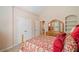 Comfortable bedroom with a double door closet and an arched window reflected in the mirror at 132 Copper Hills Dr, Canton, GA 30114