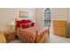 Comfortable bedroom featuring a large window, a decorative bedspread, and matching wooden furniture at 132 Copper Hills Dr, Canton, GA 30114