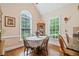 Bright dining room with hardwood floors, a round table, and large windows at 132 Copper Hills Dr, Canton, GA 30114