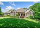 Beautiful stone and siding home with mature landscaping, green lawn, and a welcoming facade at 132 Copper Hills Dr, Canton, GA 30114