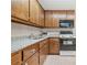 Kitchen featuring wooden cabinets, granite counters, and appliances at 132 Copper Hills Dr, Canton, GA 30114