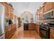 Open kitchen featuring wood cabinets, vaulted ceiling and stainless steel appliances at 132 Copper Hills Dr, Canton, GA 30114