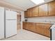 Kitchen featuring wooden cabinets, granite counters, and a white refrigerator at 132 Copper Hills Dr, Canton, GA 30114