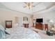 Comfortable main bedroom with a tray ceiling, ceiling fan, and a glimpse into the adjoining bathroom at 132 Copper Hills Dr, Canton, GA 30114