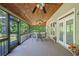 Relaxing screened-in porch with wood ceiling creates a perfect outdoor dining or lounging area at 132 Copper Hills Dr, Canton, GA 30114