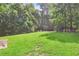 Spacious backyard with lush green grass and mature trees, offering a serene outdoor space for recreation and relaxation at 1832 Gordon Ne Mnr, Atlanta, GA 30307