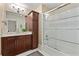Bathroom with dark wood cabinets, marble countertops, and a glass-enclosed shower at 1832 Gordon Ne Mnr, Atlanta, GA 30307
