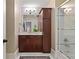Bathroom with dark wood cabinets, marble countertops, and a glass-enclosed shower at 1832 Gordon Ne Mnr, Atlanta, GA 30307