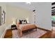 Bedroom featuring hardwood floors, exposed beams, and neutral decor at 1832 Gordon Ne Mnr, Atlanta, GA 30307