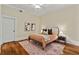Cozy bedroom featuring hardwood floors, a comfortable bed, and neutral decor at 1832 Gordon Ne Mnr, Atlanta, GA 30307