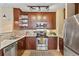 Bright kitchen with stainless steel appliances, dark wood cabinets, and marble countertops at 1832 Gordon Ne Mnr, Atlanta, GA 30307