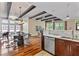Open-concept kitchen and dining area, hardwood floors, stainless steel dishwasher, and marble countertops at 1832 Gordon Ne Mnr, Atlanta, GA 30307