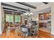 Open floor plan combines the living, dining, and kitchen areas with exposed beams and hardwood floors at 1832 Gordon Ne Mnr, Atlanta, GA 30307