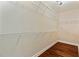 Spacious walk-in closet with hardwood floors and multiple levels of metal shelving for organized storage at 1832 Gordon Ne Mnr, Atlanta, GA 30307