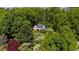 Aerial view of a beautiful estate featuring lush landscaping, mature trees, and a charming home at 45 Michelle Ne Cir, Atlanta, GA 30342