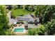 Aerial view of a stunning home with a pool, stone patio, lush landscaping, and mature trees at 45 Michelle Ne Cir, Atlanta, GA 30342